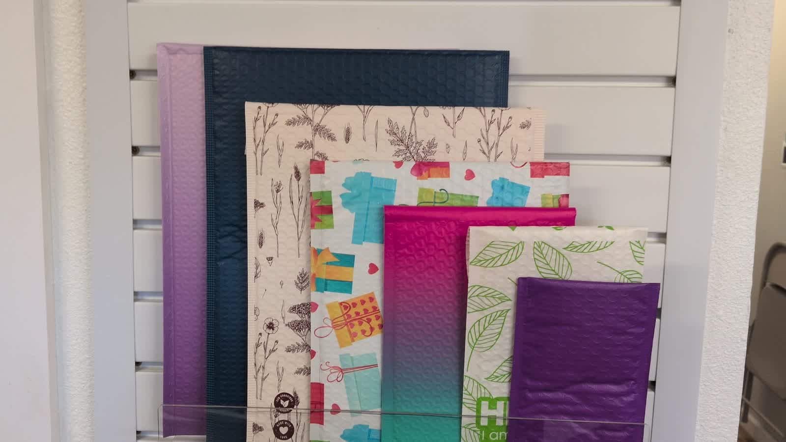Padded and decorative mailers on the shop wall